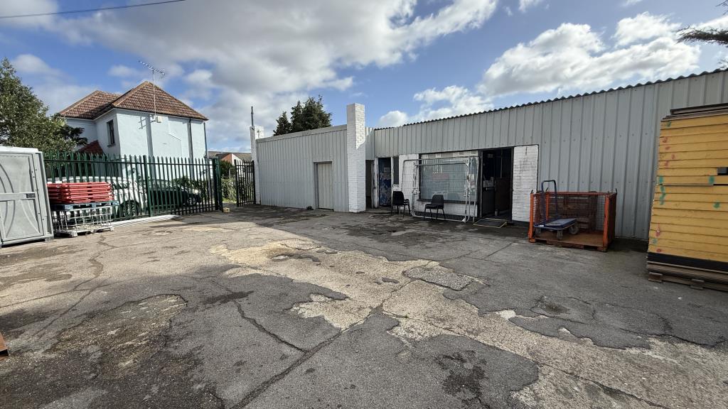 Lot: 34 - YARD, GARAGES AND LIGHT INDUSTRIAL PREMISES WITH POTENTIAL - External image of yard area inside security fencing